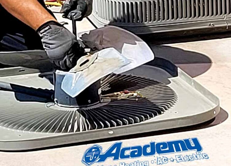Academy Plumbing technician repairing an air conditioner condenser fan in Albuquerque